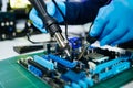 The technician repairing the motherboard in the lab with copy space. the concept of computer hardware, mobile phone, electronic, Royalty Free Stock Photo