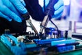 The technician repairing the motherboard in the lab with copy space. the concept of computer hardware, mobile phone, electronic, Royalty Free Stock Photo