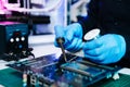 The technician repairing the motherboard in the lab with copy space. the concept of computer hardware, mobile phone, electronic, Royalty Free Stock Photo