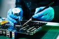 The technician repairing the motherboard in the lab with copy space. the concept of computer hardware, mobile phone, electronic, Royalty Free Stock Photo