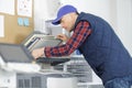 technician repairing office photocopier Royalty Free Stock Photo