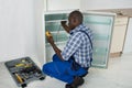 Technician Repairing Refrigerator Appliance Royalty Free Stock Photo