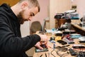 The technician repairing the smartphone motherboard in the lab. Concept of computer hardware, mobile phone, electronic, repairing Royalty Free Stock Photo