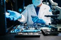 IT technician repairing smartphone and working on motherboard in a modern lab. Electronics, tech repair, digital tools, precision Royalty Free Stock Photo