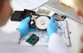 Technician repairs computer hard drive from motherboard Royalty Free Stock Photo