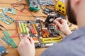 Technician Repairs a Computer Motherboard With Tools in a Workspace Setting Royalty Free Stock Photo