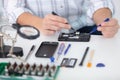 technician repairs smartphone with precision tools Royalty Free Stock Photo
