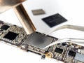 Technician replacing flash storage of smartphone motherboard