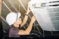 Technician runs the air-conditioning refrigerant from the tank