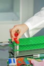 Technician puts test tube to rack Royalty Free Stock Photo