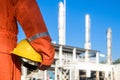 Technician with safety helmet in hand standing above oil refinery plant Royalty Free Stock Photo