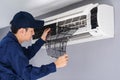 Technician service removing air filter of air conditioner for cleaning Royalty Free Stock Photo