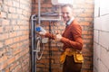 Technician servicing an hot-water heater. Royalty Free Stock Photo