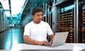 Technician Sitting next to the server in the data storage room Royalty Free Stock Photo