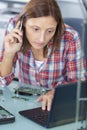 Technician sitting in office running diagnostics in large data center Royalty Free Stock Photo