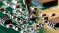 Technician soldering electronic component on circuit board with precision Royalty Free Stock Photo