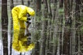 Technician taking sample of water to container in floods contaminated area