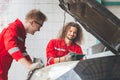 Technician team checking modern car at garage, Young Caucasian car mechanic with a checklist, Mechanics in uniform are working in Royalty Free Stock Photo