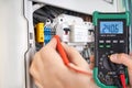 Technician Testing Voltage with Digital Multimeter Royalty Free Stock Photo