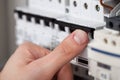 Technician turning on switch in fusebox Royalty Free Stock Photo