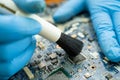 Technician use brush and air blower ball to clean dust in circuit board computer. Repair upgrade and maintenance technology