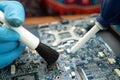 Technician use brush and air blower ball to clean dust in circuit board computer. Repair upgrade and maintenance technology Royalty Free Stock Photo