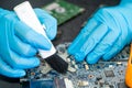 Technician use brush and air blower ball to clean dust in circuit board computer. Repair upgrade and maintenance technology Royalty Free Stock Photo