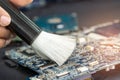 Technician use brush and air blower ball to clean dust in circuit board computer. Repair upgrade and maintenance technology Royalty Free Stock Photo