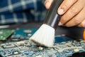 Technician use brush and air blower ball to clean dust in circuit board computer. Repair upgrade and maintenance technology Royalty Free Stock Photo