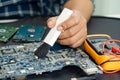 Technician use brush and air blower ball to clean dust in circuit board computer. Repair upgrade and maintenance technology Royalty Free Stock Photo