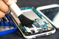 Technician use brush and air blower ball to clean dust in circuit board computer. Repair upgrade and maintenance technology Royalty Free Stock Photo