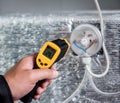 Technician use infrared thermal imaging camera to check temperature at fuse-box Royalty Free Stock Photo