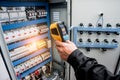 Technician use infrared thermal imaging camera to check temperature at fuse-box Royalty Free Stock Photo