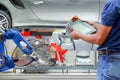 Technician use wireless remote for setting program for control industrial robot Royalty Free Stock Photo