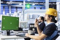 Technician uses green screen PC to monitor solar panel manufacturing plant