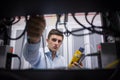 Technician using cable tester while fixing server Royalty Free Stock Photo