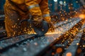 Technician using electric wheel cutting steel in a large factory