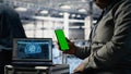 Technician using green screen smartphone in server hub while optimizing AI Royalty Free Stock Photo