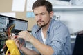 technician using voltage meter for voltage measurement in computer Royalty Free Stock Photo