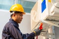 Technician vacuum pump evacuates and checking air conditioner, After-sales service concept Royalty Free Stock Photo