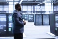 Technician walking in server hub, checking hardware Royalty Free Stock Photo