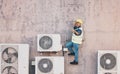 Technician woman, air conditioning maintenance or thumbs up with smile, success or portrait on ladder by building wall Royalty Free Stock Photo