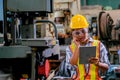 Technician woman with tablet check or maintenance the machine in factory Royalty Free Stock Photo
