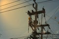 Technician work on high voltage electicity pole with copy space and reflect light