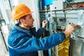 Technician worker adjusting elevator mechanism of lift Royalty Free Stock Photo