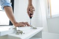 Technician Worker Fixing The Door Lock With Screwdriver in to wood. creating new things At Home, renovation and installing concept Royalty Free Stock Photo