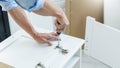 Technician Worker Fixing The Door Lock With Screwdriver in to wood. creating new things At Home, renovation and installing concept Royalty Free Stock Photo