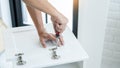 Technician Worker Fixing The Door Lock With Screwdriver in to wood. creating new things At Home, renovation and installing concept Royalty Free Stock Photo