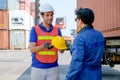 Technician or worker give safety helmet to his co-worker in cargo container shipping area