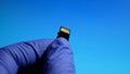 The technician worker holding in micro SD card repairing in service center on blue background Royalty Free Stock Photo